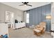 Bedroom with accent wall, ceiling fan, and view of bathroom at 765 Terrapin Dr, Debary, FL 32713