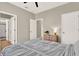Bedroom boasts fan, closet, neutral walls, and view to bathroom shower from bed at 765 Terrapin Dr, Debary, FL 32713