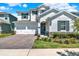 Charming two-story home with a two-car garage, brick driveway, manicured lawn, and stone veneer at 765 Terrapin Dr, Debary, FL 32713