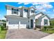 Charming two-story home with a two-car garage, brick driveway, manicured lawn, and stone veneer accents at 765 Terrapin Dr, Debary, FL 32713