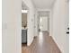 Inviting hallway with wood-look tile flooring and views of the entryway and powder bath at 765 Terrapin Dr, Debary, FL 32713