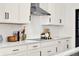 A beautifully designed kitchen featuring white cabinets, quartz countertops, and a stylish herringbone tile backsplash at 765 Terrapin Dr, Debary, FL 32713