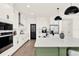 This modern kitchen boasts stainless steel appliances, a large island with seating, and elegant white cabinetry at 765 Terrapin Dr, Debary, FL 32713