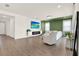 Bright and airy living room with a modern fireplace, comfortable seating, and a stylish green accent wall at 765 Terrapin Dr, Debary, FL 32713