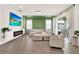 Inviting living room featuring a comfortable sectional sofa, fireplace, green accent wall, and modern design at 765 Terrapin Dr, Debary, FL 32713