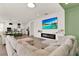 Spacious living room featuring a modern fireplace, large TV, and open floor plan to kitchen at 765 Terrapin Dr, Debary, FL 32713