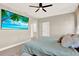 This bedroom has a wall-mounted television, ceiling fan, and neutral decor at 765 Terrapin Dr, Debary, FL 32713