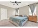 Neutral primary bedroom with a ceiling fan, carpet, and curtains at 765 Terrapin Dr, Debary, FL 32713