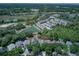 Aerial view of a home with a private pool, beautifully situated next to a serene pond and lush greenery at 821 N Lake Claire Cir, Oviedo, FL 32765