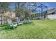 Spacious backyard featuring well-maintained lawn and comfortable Adirondack chairs, perfect for outdoor relaxation at 821 N Lake Claire Cir, Oviedo, FL 32765