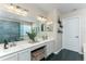 Bathroom featuring double sinks, a large mirror, and ample counter space at 821 N Lake Claire Cir, Oviedo, FL 32765