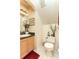 Cozy half bathroom with neutral wall color, framed mirror, and standard toilet at 821 N Lake Claire Cir, Oviedo, FL 32765
