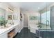 Bright bathroom with a double sink vanity, soaking tub, and walk-in shower at 821 N Lake Claire Cir, Oviedo, FL 32765