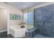 Bathroom featuring a luxurious soaking tub and a modern glass-enclosed shower at 821 N Lake Claire Cir, Oviedo, FL 32765