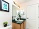 Bathroom featuring vanity with green countertops, toilet and white door at 821 N Lake Claire Cir, Oviedo, FL 32765