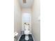 Cozy half-bathroom with dark tile flooring, toilet, and white walls at 821 N Lake Claire Cir, Oviedo, FL 32765