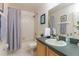 Bathroom view with shower, tub, toilet, vanity, and green countertops at 821 N Lake Claire Cir, Oviedo, FL 32765