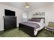 Bedroom featuring a queen bed with dark wood frame, carpet flooring, and TV at 821 N Lake Claire Cir, Oviedo, FL 32765