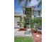Charming front entry featuring double doors, decorative shrubs, American flag, and a wrought-iron bench at 821 N Lake Claire Cir, Oviedo, FL 32765