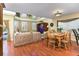 Bright living room with hardwood floors, high ceilings, and a view of the pool at 821 N Lake Claire Cir, Oviedo, FL 32765