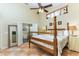 Main bedroom featuring a four-poster bed, high ceiling, and bathroom entrance at 821 N Lake Claire Cir, Oviedo, FL 32765