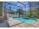 Gorgeous in-ground pool with screened enclosure, spacious patio, and lush landscaping at 821 N Lake Claire Cir, Oviedo, FL 32765