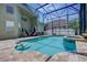 Beautiful in-ground pool, a spa, patio seating, and a screened enclosure at 821 N Lake Claire Cir, Oviedo, FL 32765