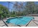 Beautiful in-ground pool with screened enclosure, seamlessly integrating indoor/outdoor living at 821 N Lake Claire Cir, Oviedo, FL 32765