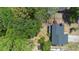 Aerial view of a home with a deck and surrounded by mature trees and landscaping at 825 Mellowood Ave, Orlando, FL 32825