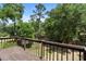 Wooden back deck with green yard and mature trees at 825 Mellowood Ave, Orlando, FL 32825