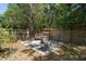 Seating area in backyard with trees and a wooden fence at 825 Mellowood Ave, Orlando, FL 32825
