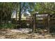 Backyard with swing bench and a view of lush trees and a wooden fence at 825 Mellowood Ave, Orlando, FL 32825