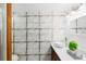 Bathroom featuring a metal tile accent wall, vessel sink, and wood cabinet at 825 Mellowood Ave, Orlando, FL 32825