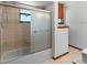 Bathroom with a tiled shower and decorative glass shower door at 825 Mellowood Ave, Orlando, FL 32825