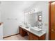 Bright bathroom featuring double sinks, a spacious countertop, and a large mirror at 825 Mellowood Ave, Orlando, FL 32825