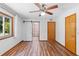 Bedroom features ceiling fan and ensuite bathroom with sliding barn door at 825 Mellowood Ave, Orlando, FL 32825