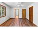 Bedroom featuring hardwood floors, a ceiling fan, and closet storage at 825 Mellowood Ave, Orlando, FL 32825