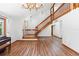 Bright entryway featuring hardwood floors, staircase with wood railing, and modern lighting at 825 Mellowood Ave, Orlando, FL 32825
