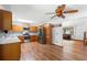 Open kitchen area with stainless steel refrigerator, wood cabinets and view of the piano in the next room at 825 Mellowood Ave, Orlando, FL 32825