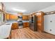 Bright kitchen with stainless steel appliances and wood cabinetry providing ample storage space at 825 Mellowood Ave, Orlando, FL 32825