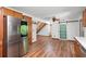 Kitchen area with a stainless steel fridge, modern lighting, and a sliding powder room door at 825 Mellowood Ave, Orlando, FL 32825