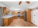 Spacious kitchen featuring stainless steel appliances and wooden cabinetry for ample storage at 825 Mellowood Ave, Orlando, FL 32825