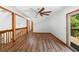 Bright living room with hardwood floors, wood railings, and a glass sliding door at 825 Mellowood Ave, Orlando, FL 32825