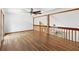 Second floor living room with hardwood floors and wood railings with spindle posts at 825 Mellowood Ave, Orlando, FL 32825