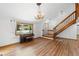 Light-filled living room boasting a piano, staircase, and lovely floors at 825 Mellowood Ave, Orlando, FL 32825