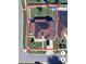 An aerial view of a home showcasing its backyard, driveway, and lush green landscaping at 8325 Sun Vista Way, Orlando, FL 32822