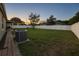 Large, well-maintained backyard with green grass, a privacy fence, and a clear view of the sunset at 8325 Sun Vista Way, Orlando, FL 32822