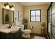 Stylish bathroom with a sleek vanity, decorative mirror, and a window at 8325 Sun Vista Way, Orlando, FL 32822