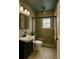 Modern bath with a sleek vanity, framed mirror, and a shower with glass at 8325 Sun Vista Way, Orlando, FL 32822