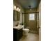 Modern bathroom features a walk-in shower, contemporary fixtures, and neutral tile, creating a spa-like retreat at 8325 Sun Vista Way, Orlando, FL 32822